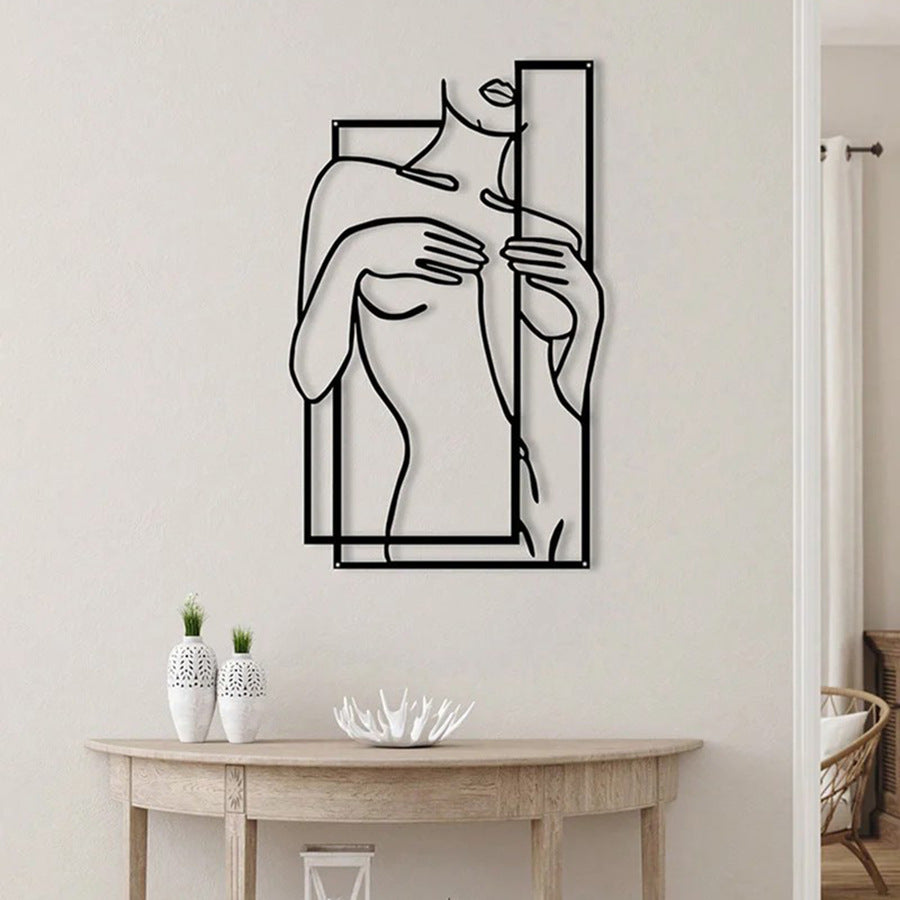 Female silhouette iron wall art featuring a line-drawn woman beside a tall frame