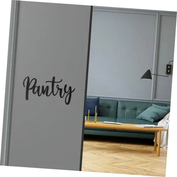 Metal pantry sign with cursive “Pantry” on a gray door panel