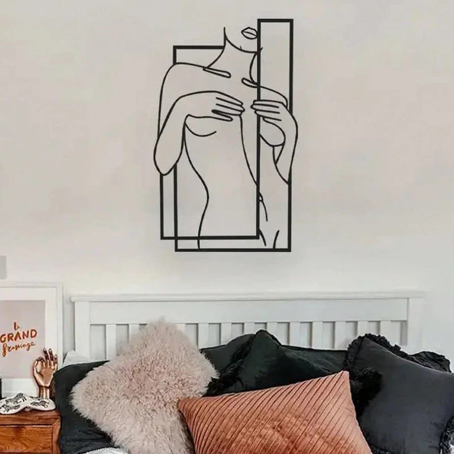 Female silhouette iron wall art with a line drawing of a woman with hands near her face