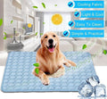 Blue pet cooling nest pad with raised bubble texture, dog resting on it