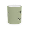 Green ceramic mug with partial Apiary Society text and bee illustration.