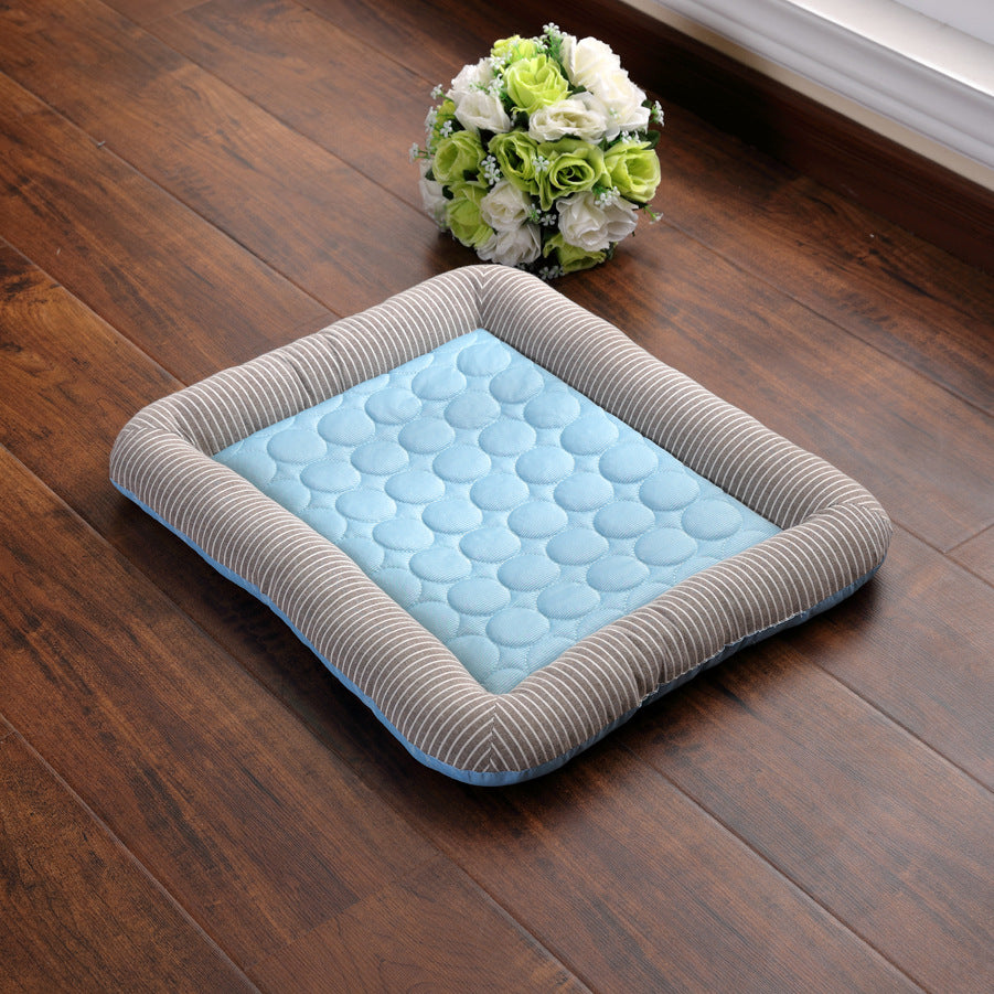 Pet cooling pad bed, blue quilted surface with gray striped sides and curved edges