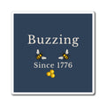 Bee refrigerator magnet close-up: dark blue square with two bees and honeycomb icon