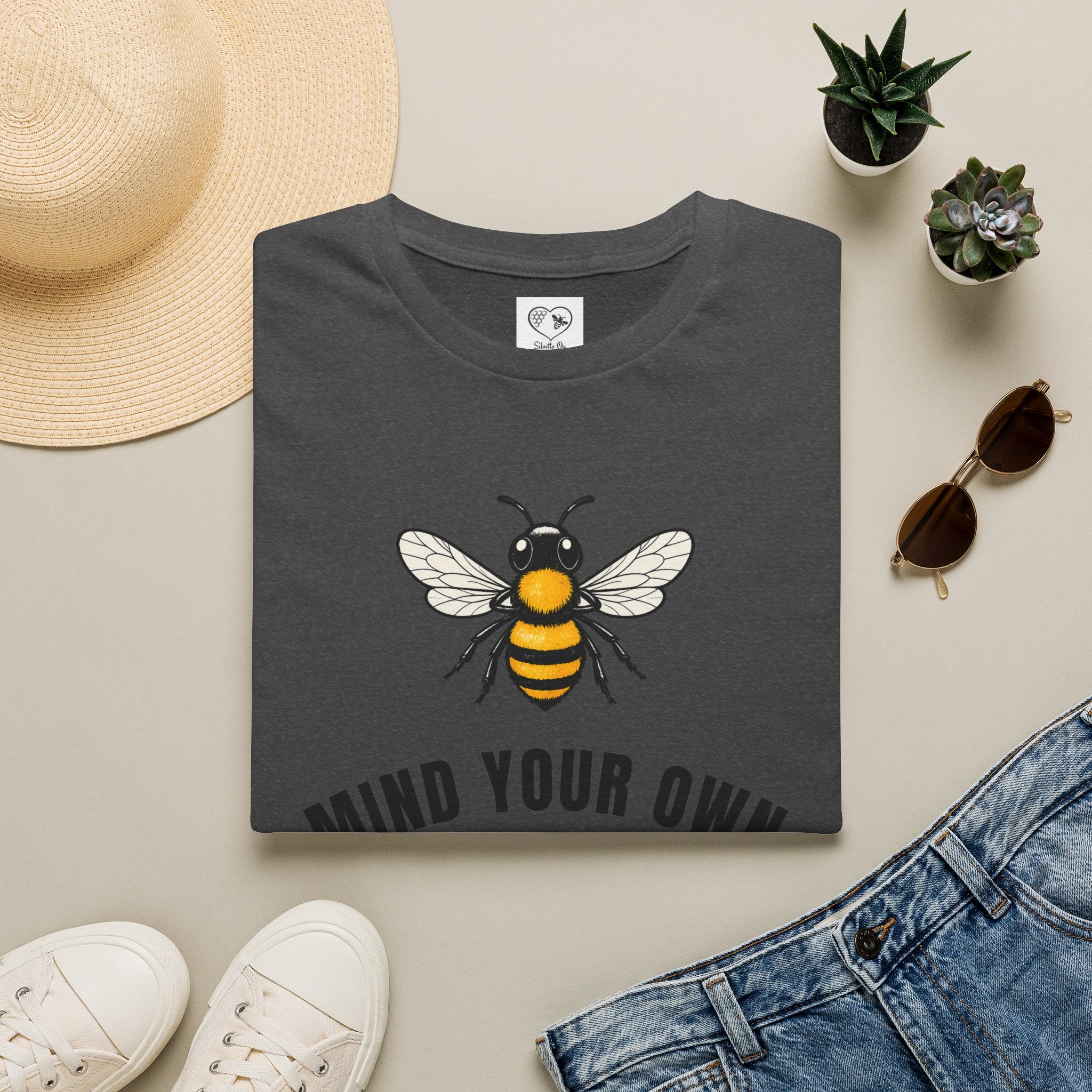 Dark heather t-shirt with bee illustration and bold "MIND YOUR OWN" text on front
