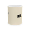 Cream ceramic mug with BEE text and honeybee graphic