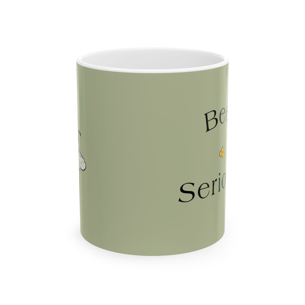 Olive green mug with 'Bee Serious' text and small bee illustration on front