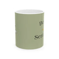 Olive green mug with 'Bee Serious' text and small bee illustration on front