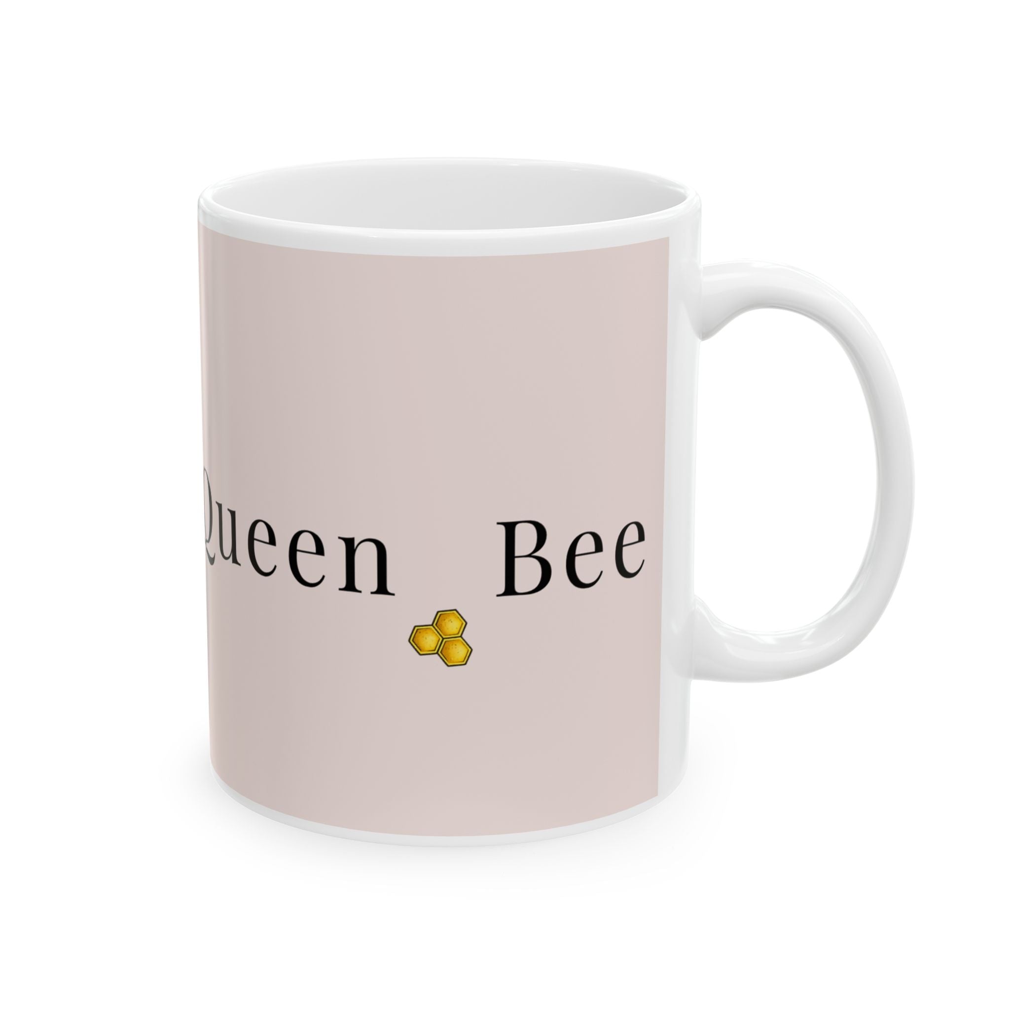 Pink ceramic coffee cup with 'Queen Bee' text and honeycomb icon