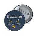 Round pin button front with “Buzzing Since 1776” and two bees, with metal back