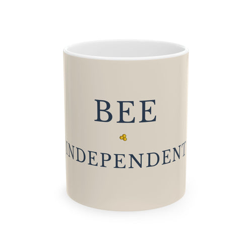 Beige ceramic mug with blue 'BEE INDEPENDENT' text and small bee emblem