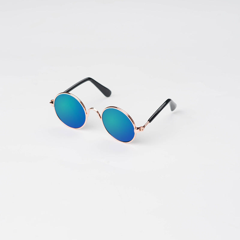 Round pet sunglasses with rose-gold frame, teal lenses, and black side arms