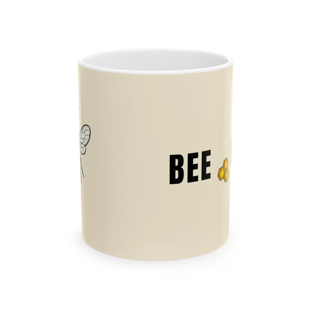 Beige ceramic mug with 'BEE' text and small bee illustration on side
