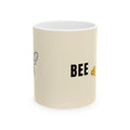 Beige ceramic mug with 'BEE' text and small bee illustration on side