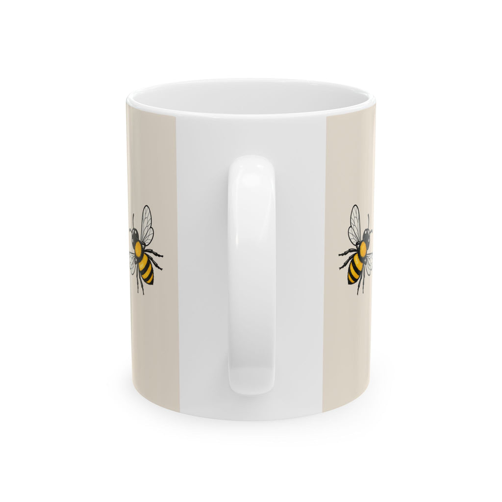 Beige ceramic mug with side bee illustrations and glossy white interior