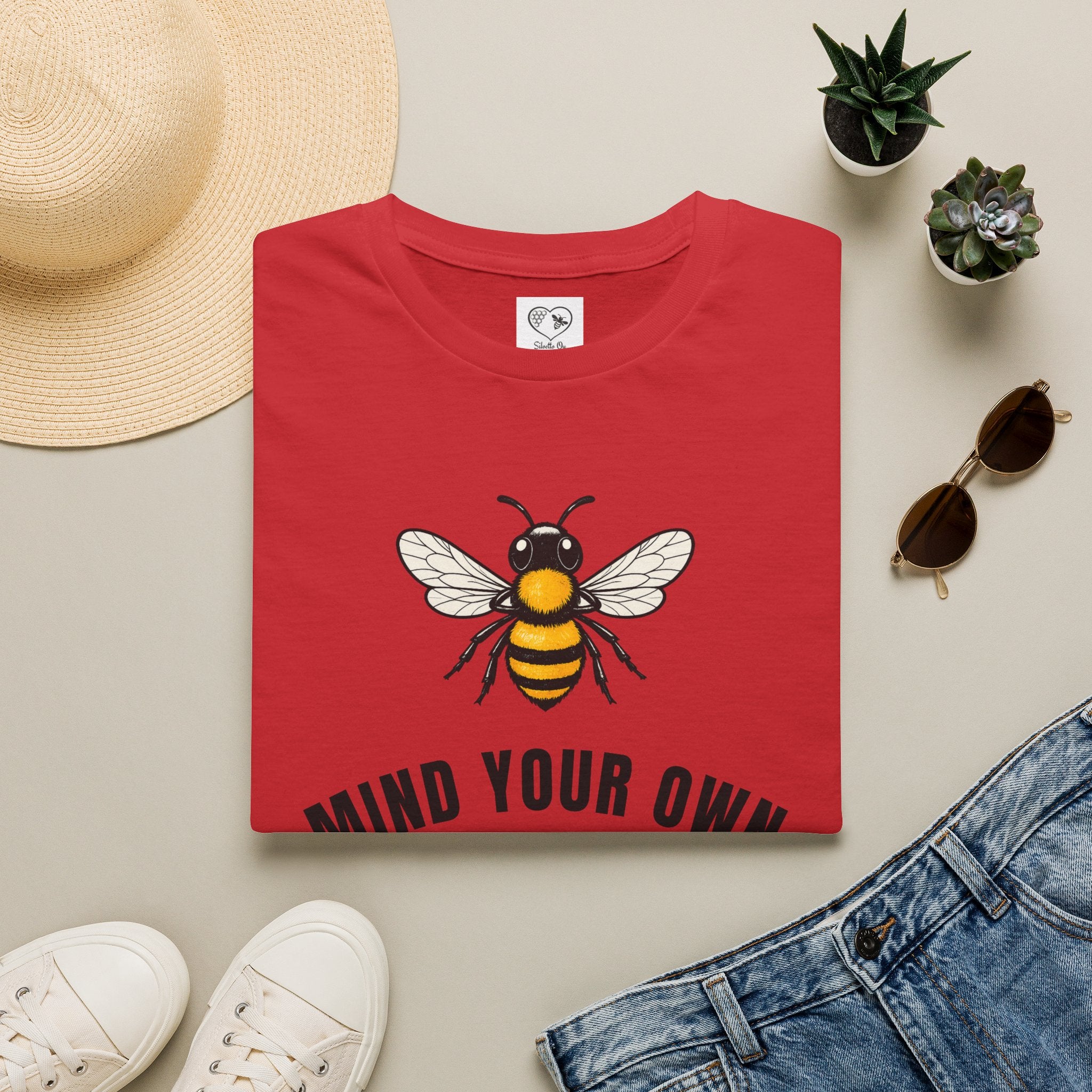 Red t-shirt with bee illustration and bold "MIND YOUR OWN" text on front