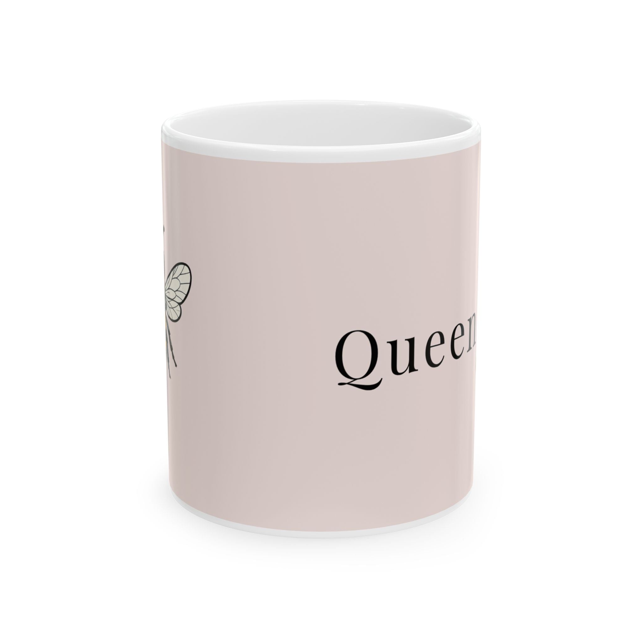 Pink ceramic coffee cup with partial 'Queen' script and bee line art