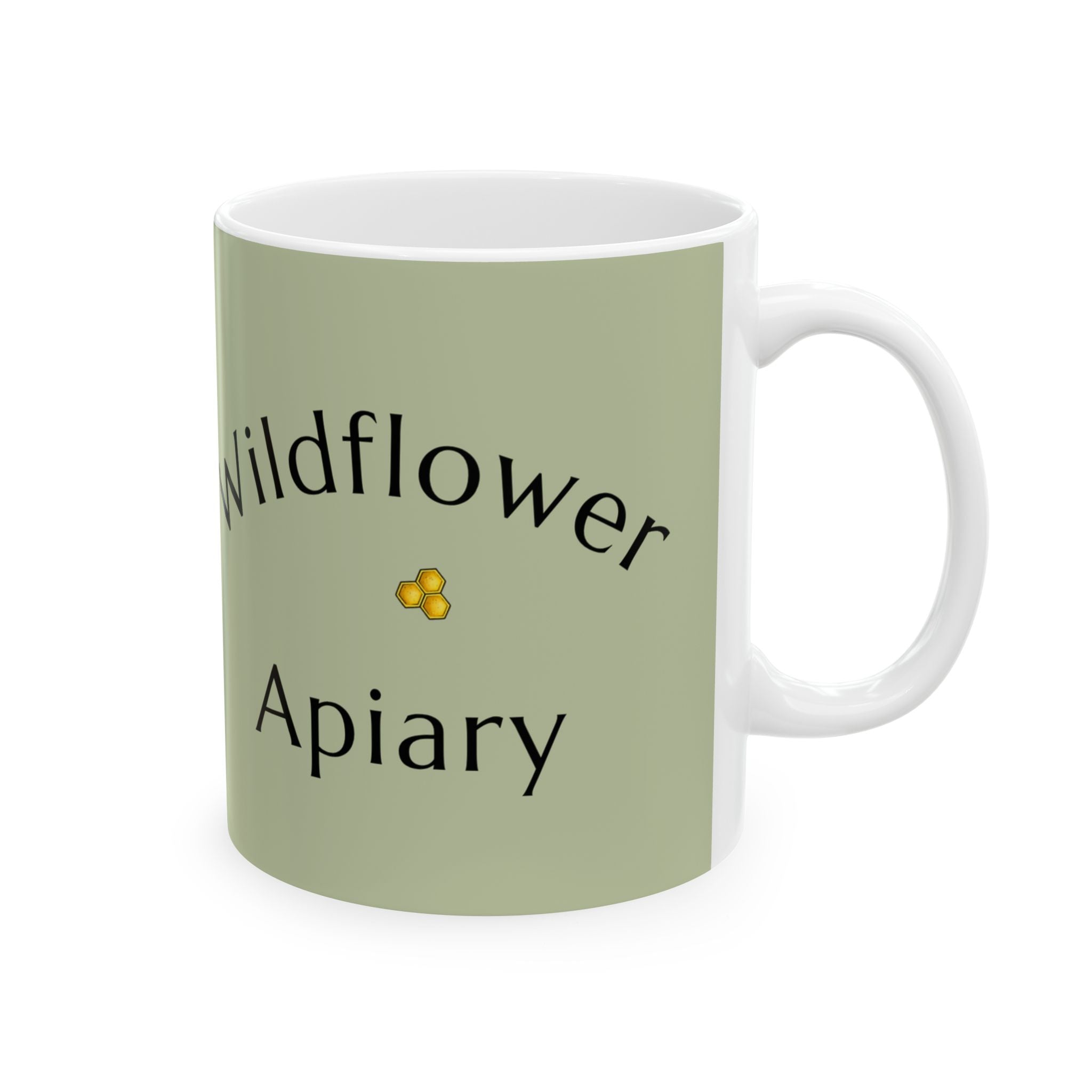 Green ceramic mug with “Wildflower Apiary” text and a small yellow flower icon