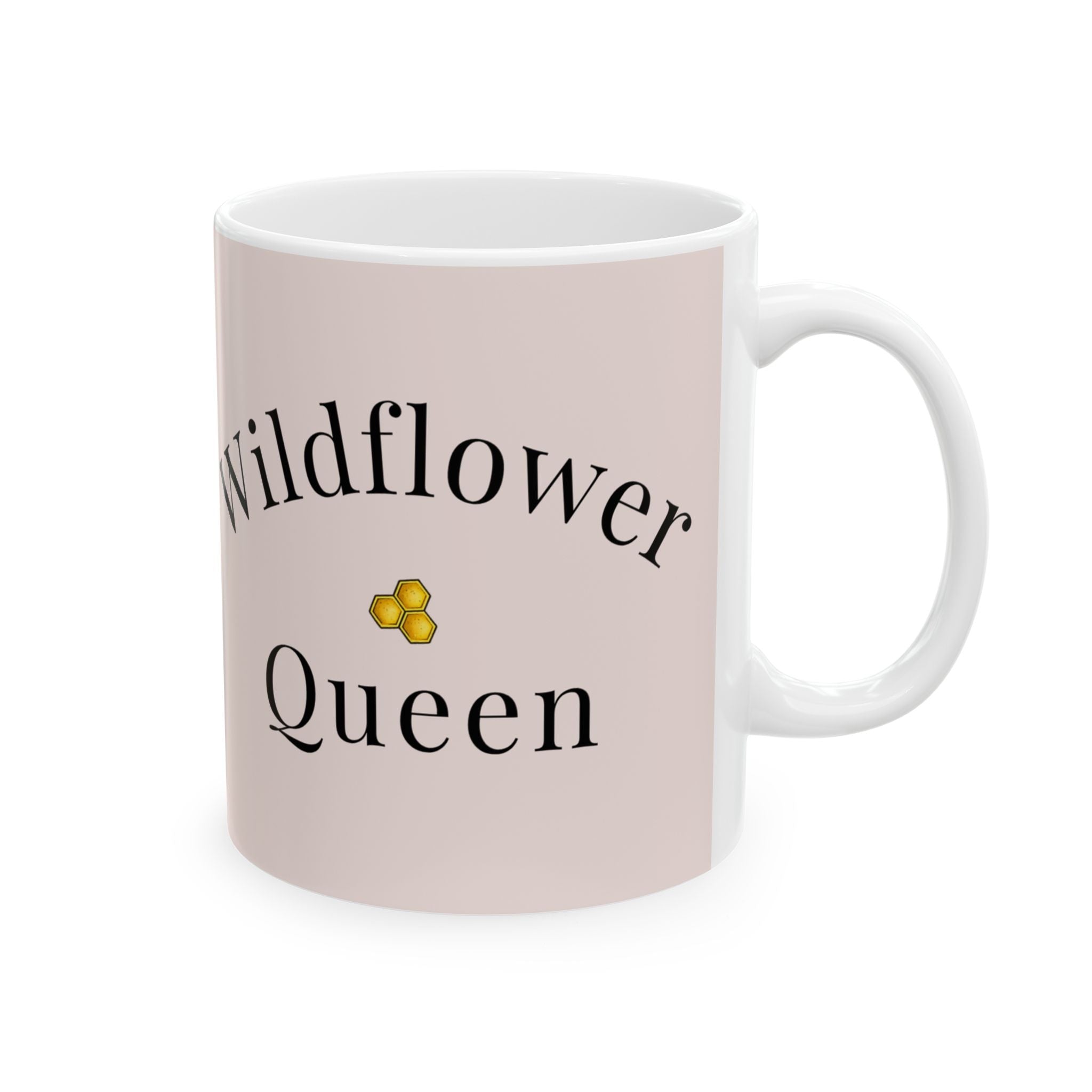 Pink ceramic coffee cup with Wildflower Queen text and small gold emblem