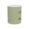 Olive green mug with bee illustration and partial Honey Bloom text