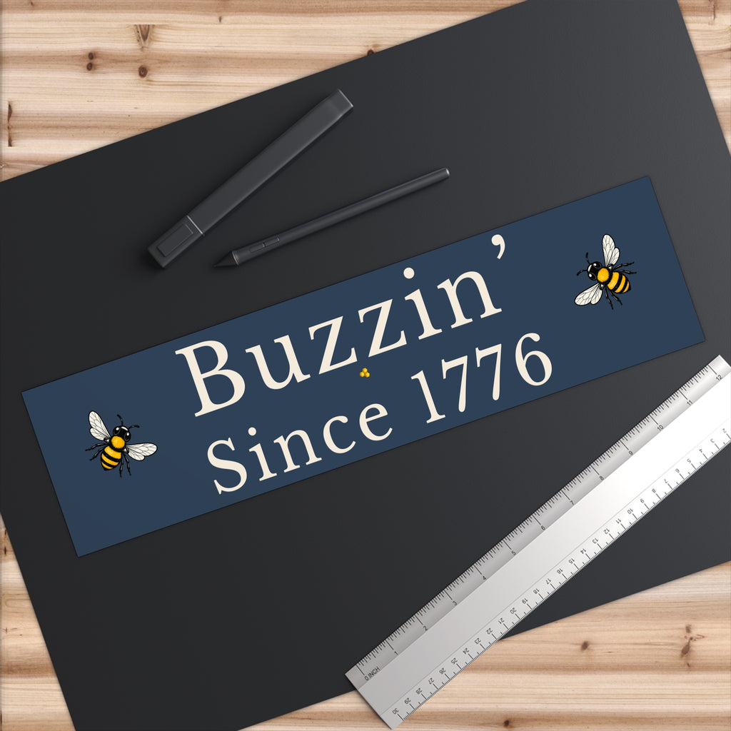 Rectangle bumper sticker, blue with large white 'Buzzin' Since 1776' and bee graphics