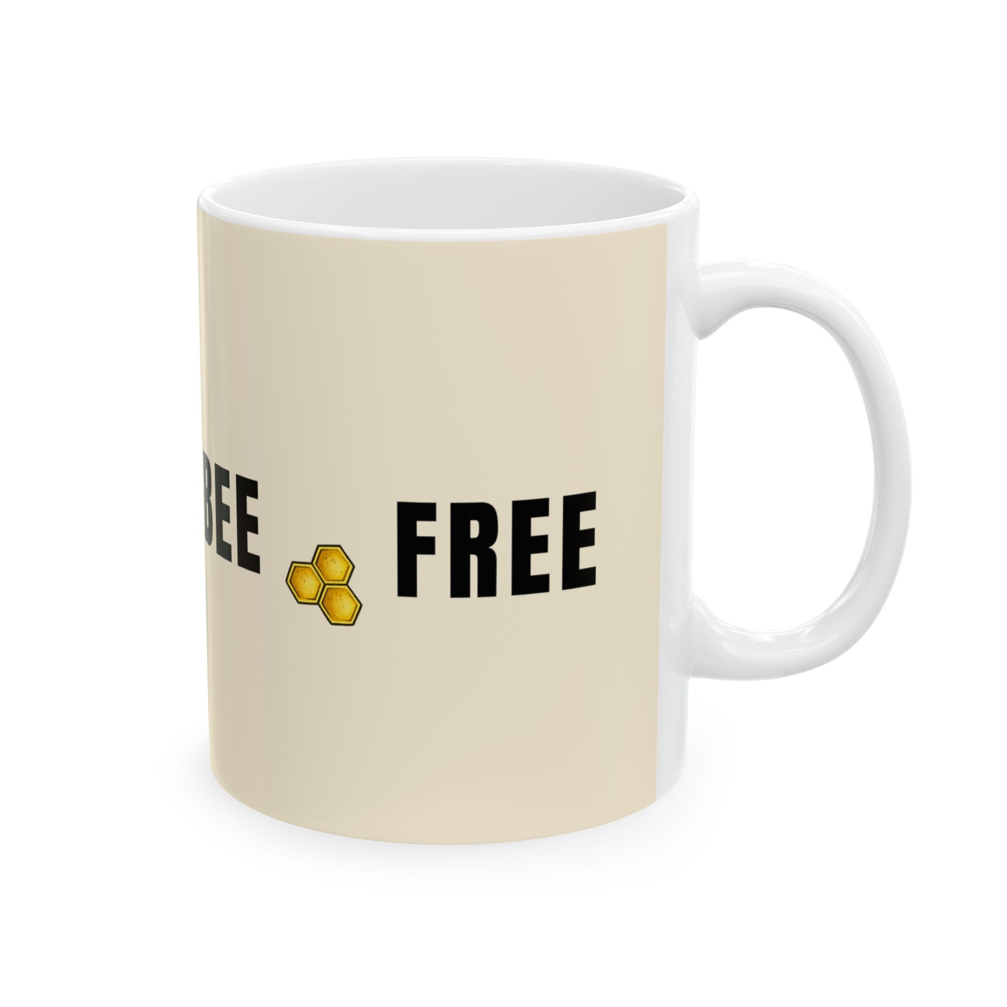 Beige ceramic mug with 'BEE FREE' text and honeycomb icon
