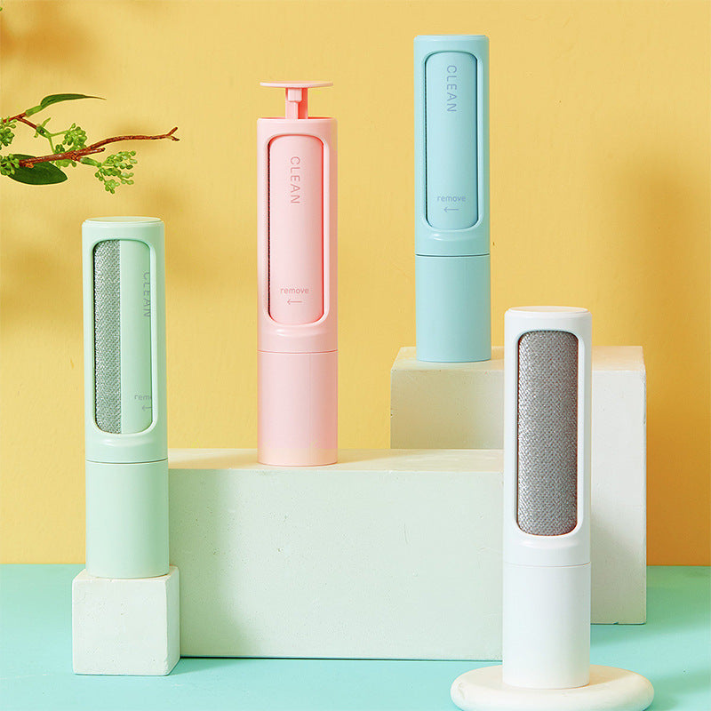 Self-cleaning pet hair remover brush set with mint and pink rollers on stands