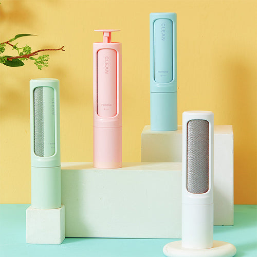 Self-cleaning pet hair remover brush set with mint and pink rollers on stands