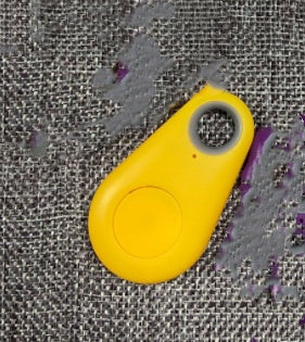 Yellow Bluetooth tracker key finder with keyring loop