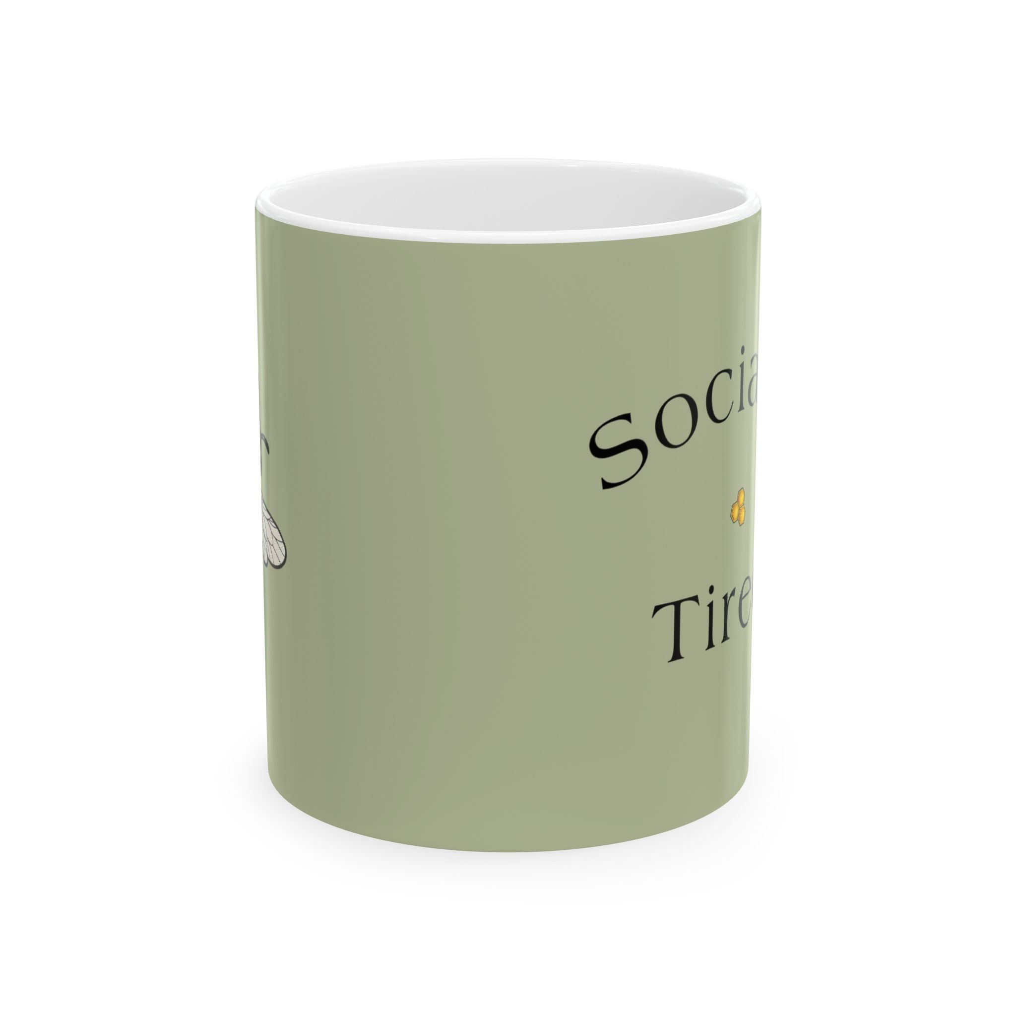 Light green ceramic mug with black 'Social...' and 'Tired' text, white rim.