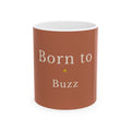 Brown ceramic mug with “Born to Buzz” text and small yellow bee graphic