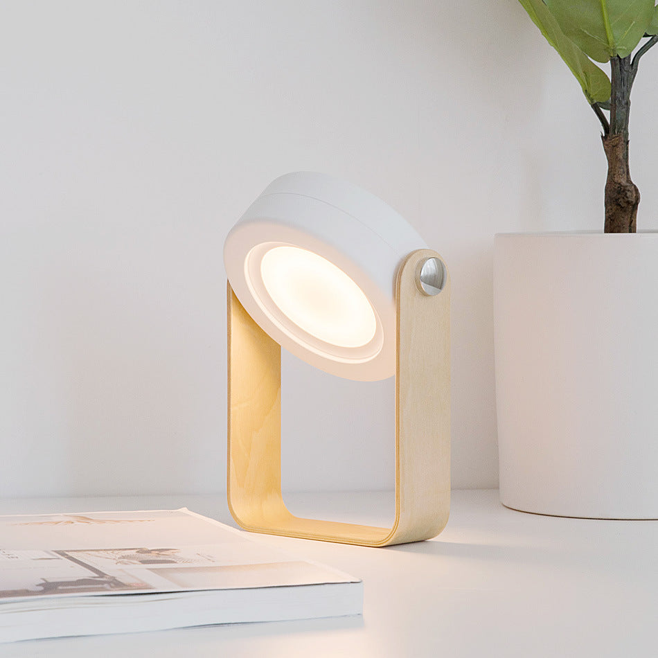 Foldable LED night lantern with warm light, wood frame, and white ridged body