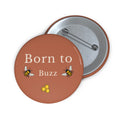 Brown enamel pin button with Born to Buzz bee and honeycomb, metal back visible