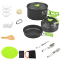 All-in-one cookware set with black pots and pan, green handles, utensils, bowls, and board