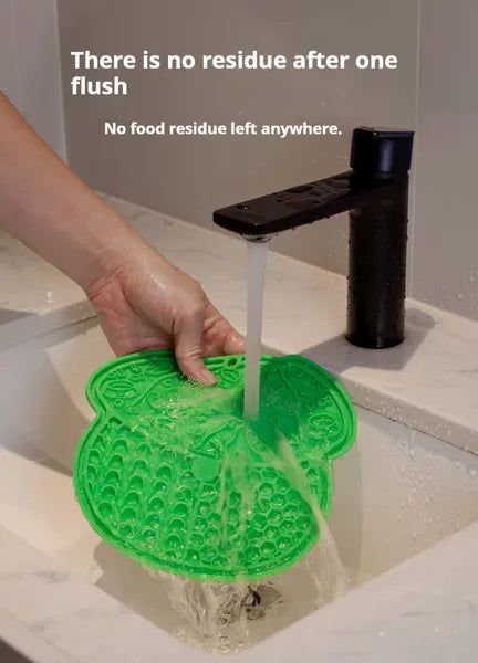 Slow feeder lick mat, green textured pad rinsed under a faucet.
