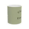 Green ceramic mug with partial black text design on side