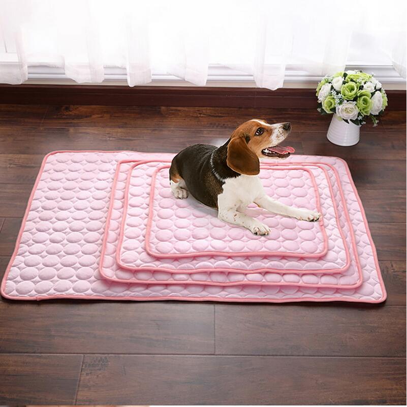 Pink pet cooling nest pad with quilted bubble texture, dog lying on it