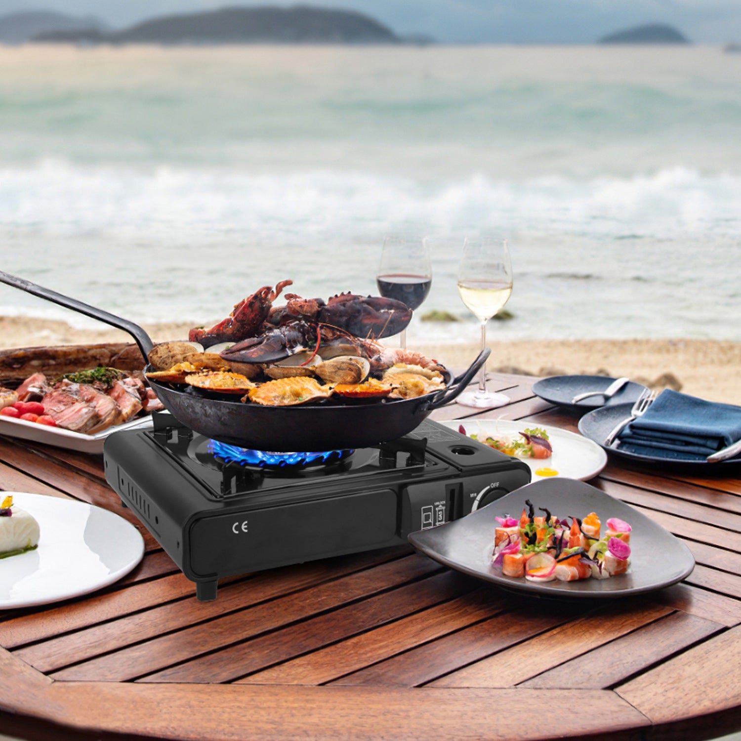 Camp stove with blue flame cooking seafood and vegetables in skillet