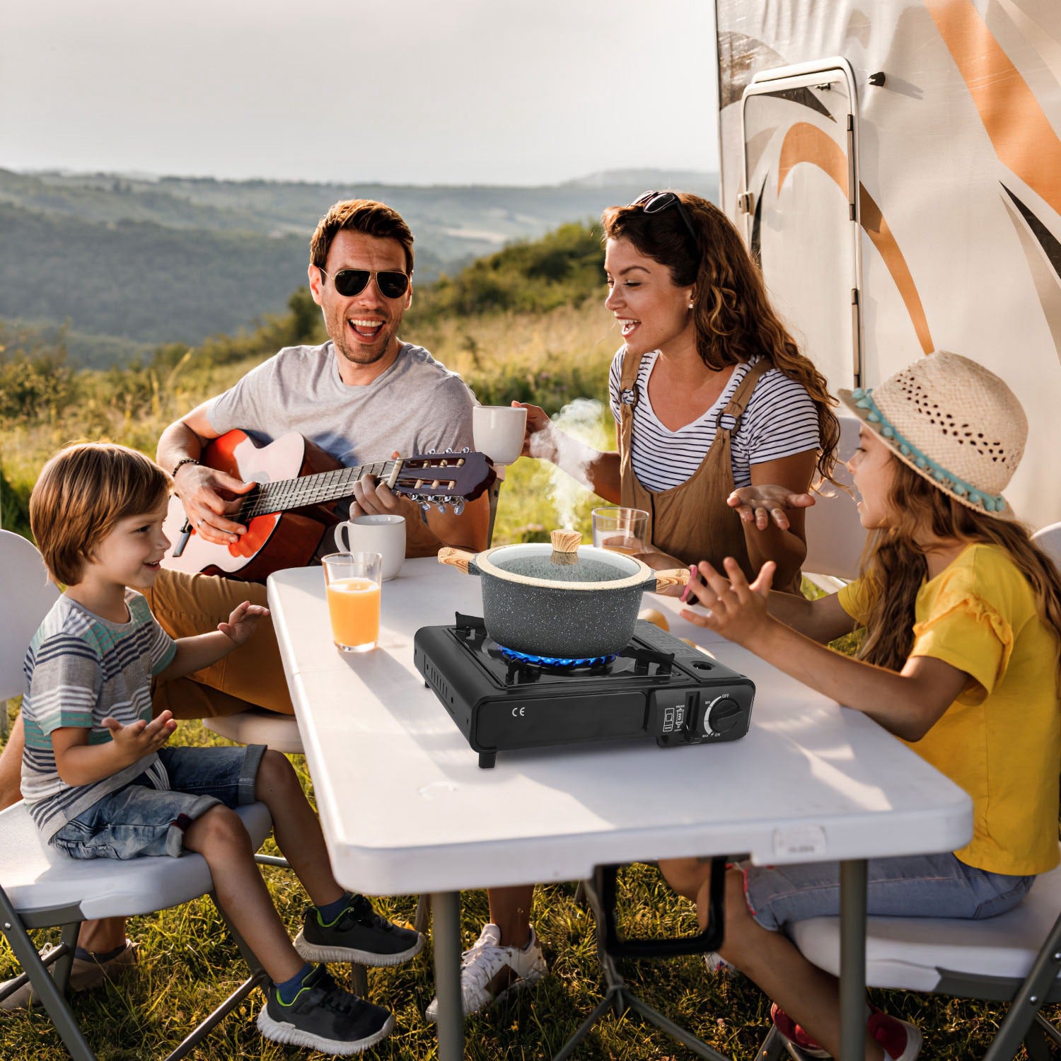 Black camp stove on outdoor picnic table with blue flame pot