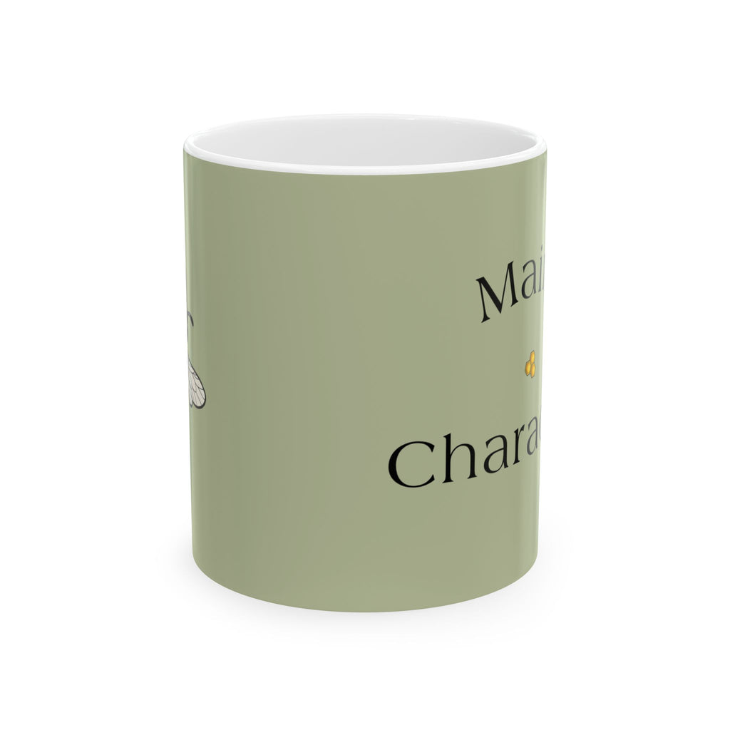 Sage green ceramic mug with black bee graphic and partial text on front
