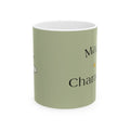 Sage green ceramic mug with black bee graphic and partial text on front