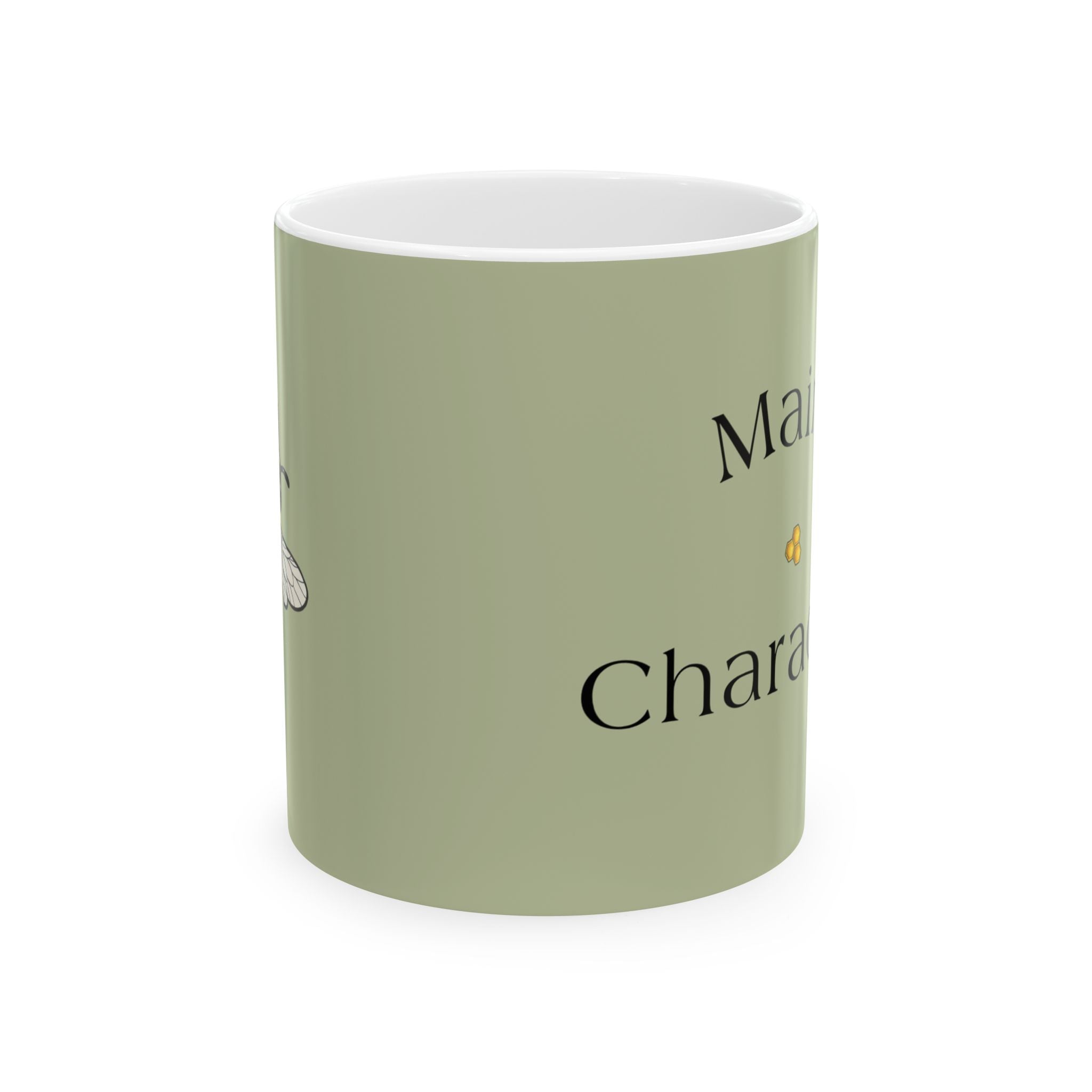 Sage green ceramic mug with black bee graphic and partial text on front
