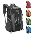 Black hiking daypack with gray panels, front zip pocket, adjustable shoulder straps