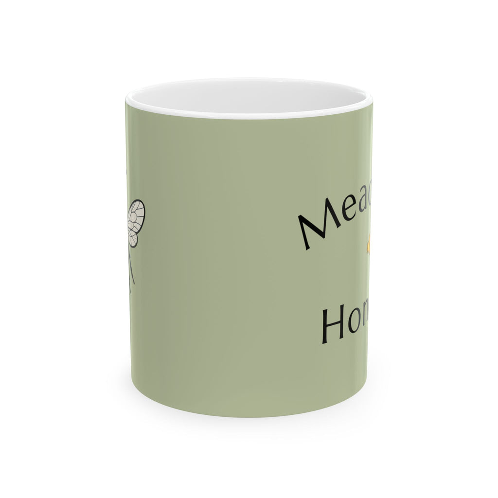 Olive green ceramic mug with partial “Meadow Honey” text and small bee icon
