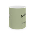 Olive green ceramic mug with partial “Meadow Honey” text and small bee icon