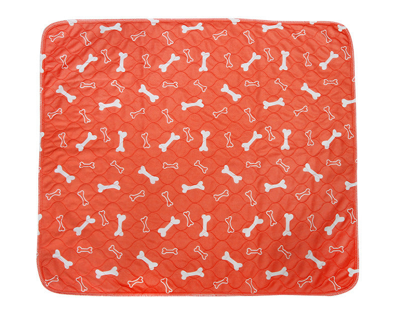 Orange waterproof pet training pad, white bone icons pattern, rounded corners