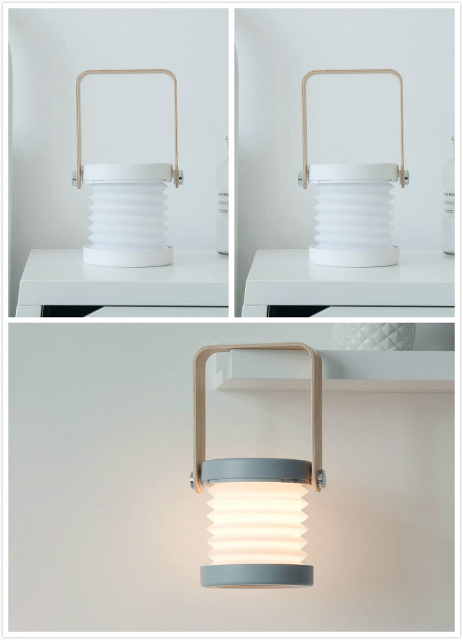 Foldable LED night lantern with white ridged body, grey base band, top carry handle