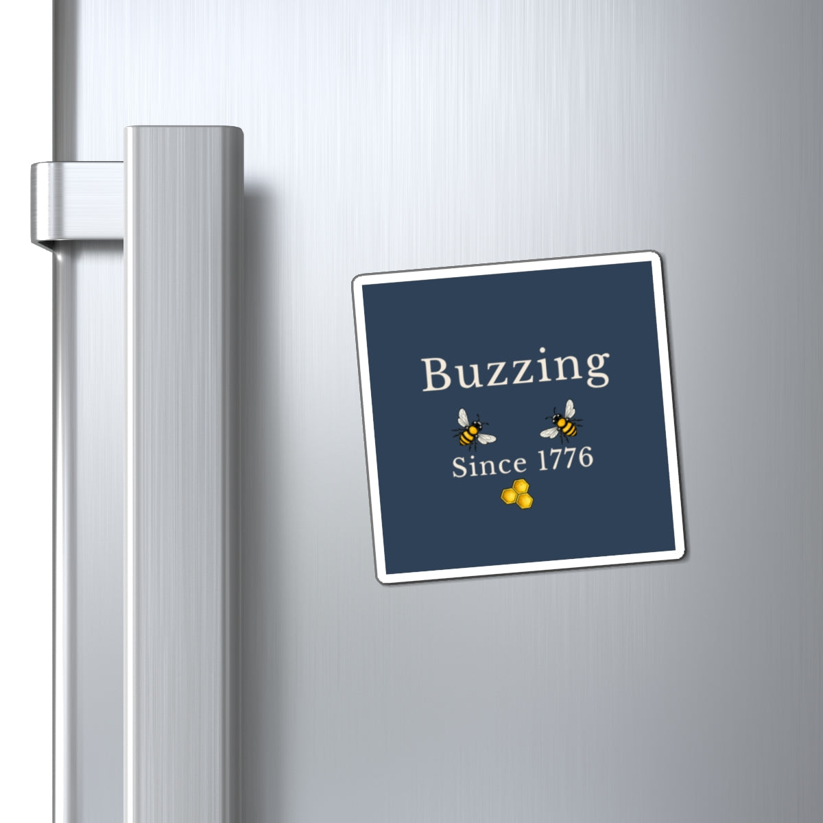 Bee refrigerator magnet on stainless steel fridge with blue "Buzzing Since 1776" square