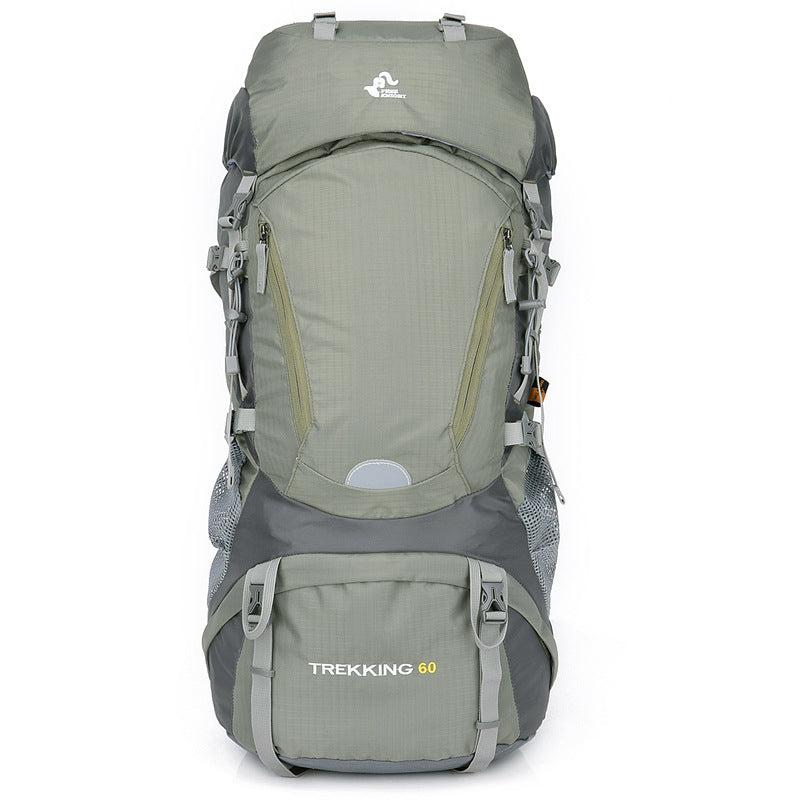 Green hiking backpack with front pocket, side straps, and padded back airflow panel