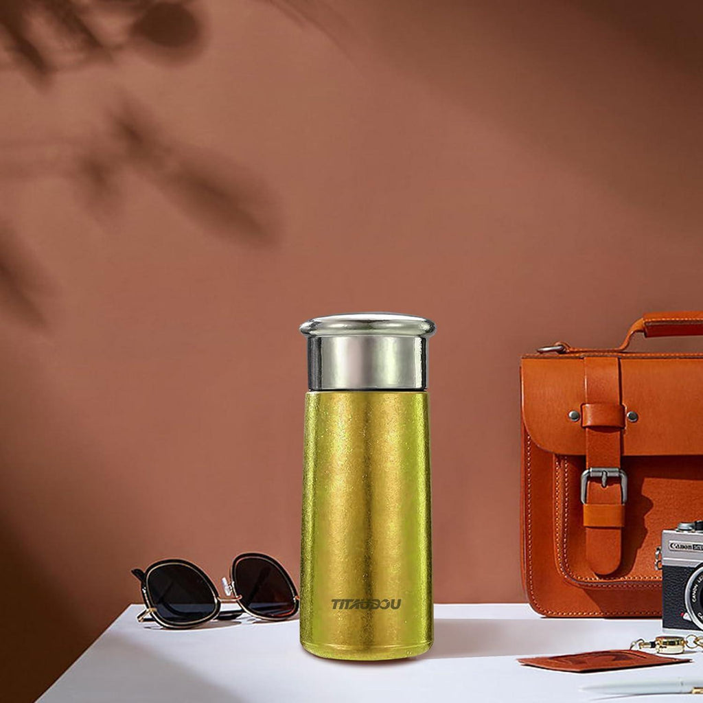 Gold vacuum insulated titanium water cup with stainless steel lid, compact travel bottle