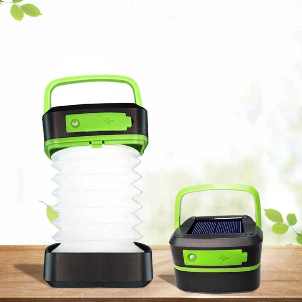 Green and black foldable solar camping lantern with top handle and stacked diffuser base